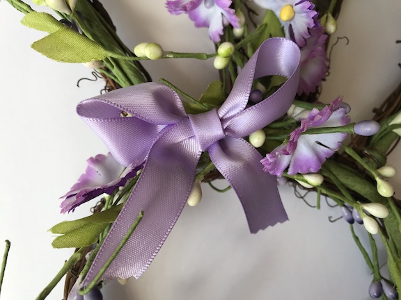 Adding a bow to the Bunny Wreath