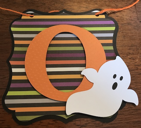 Stringing the boo banner on orange jute as a halloween banner