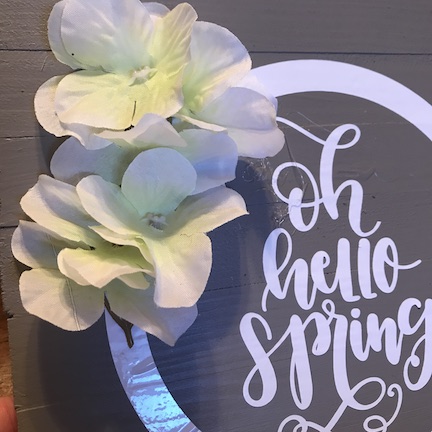 A Spring Farmhouse Kitchen Sign with flowers. Learn how to make this simple sign for $3 using the Cricut Maker and vinyl