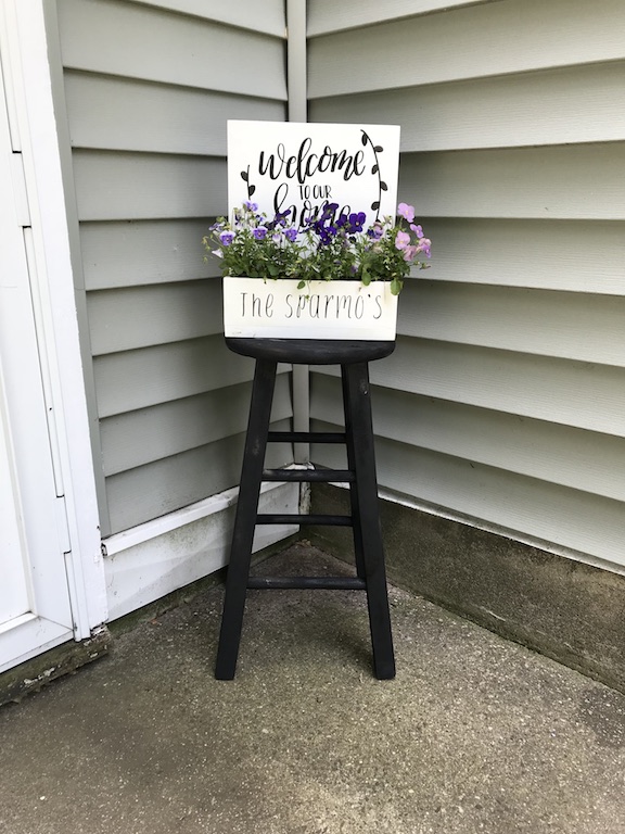 I found this old stool out for trash and gave it a second chance. Find out how I made a farmhouse stool to decorate by my door. #farmhouse #stool #DIY #upcycle #homedecor #porchdecor #farmhousestyle #Planter #flowers