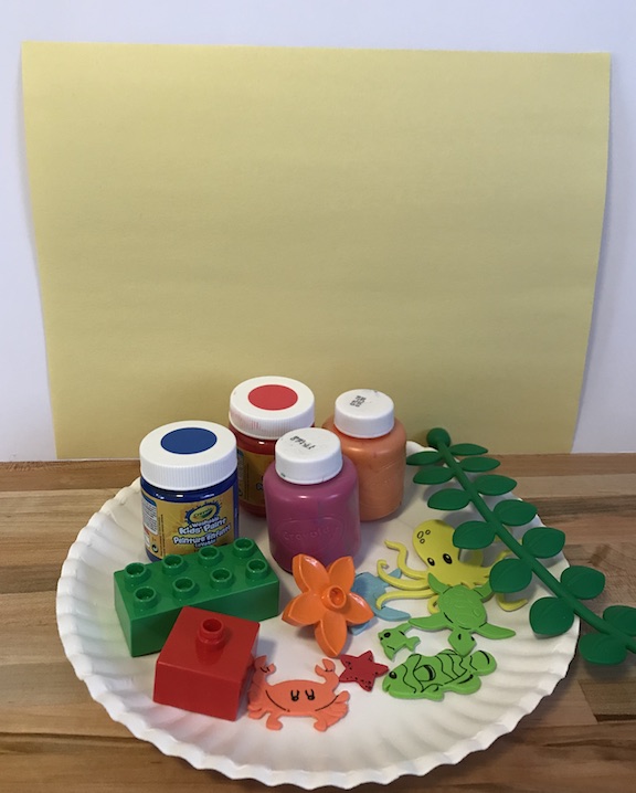 Have fun with LEGOS in a differnt way by painting an ocean scene with them. Toddlers, Preschool, Kindergarten will have fun creating this easy ocean craft with paint, LEGOS, and foam stickers. Have fun learning about ocean animals and coral reefs with this sea themed craft. #OceanTheme #SeaTheme #Kids #KidCraft #LEGO #painting #Toddlers #preschool #Kindergarten #OceanCraft #SeaCraft #DIY #PreschoolIdea #KindergartenCraft #ToddlerCraft #Paint #KidsIdea 