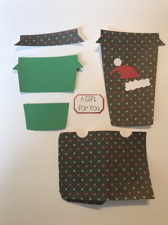 Gift cards make easy gifts, but aren't very pretty. Make your gift cards stand out in this easy to make coffee cup gift card holder for Christmas. Just find some pretty scrapbook paper and your Cricut, and get this DIY started. #DIY #Cricut #CricutMade #Coffee #GiftCardHolder #Christmas #ChristmasGift #ChristmasIdea #Xmas #scrapbook #Scrapbooking #tutorial 
