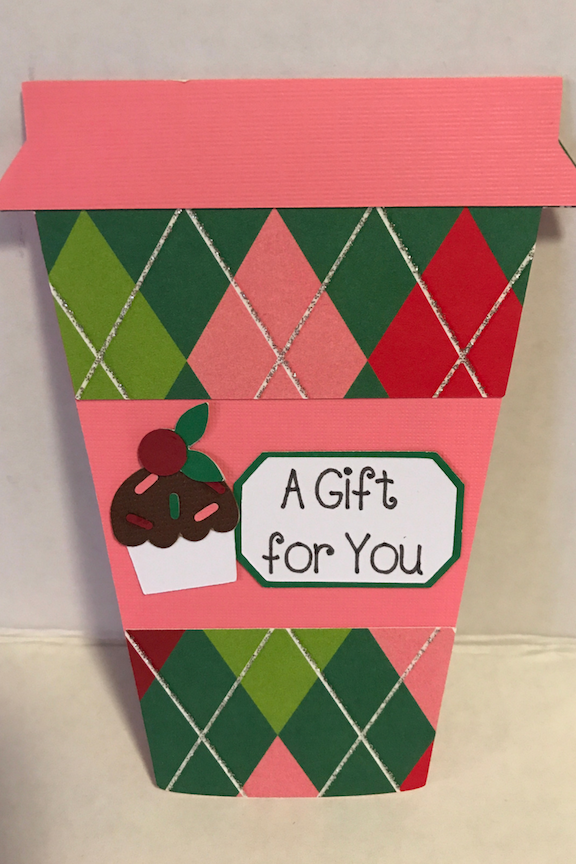 Gift cards make easy gifts, but aren't very pretty. Make your gift cards stand out in this easy to make coffee cup gift card holder for Christmas. Just find some pretty scrapbook paper and your Cricut, and get this DIY started. #DIY #Cricut #CricutMade #Coffee #GiftCardHolder #Christmas #ChristmasGift #ChristmasIdea #Xmas #scrapbook #Scrapbooking #tutorial 