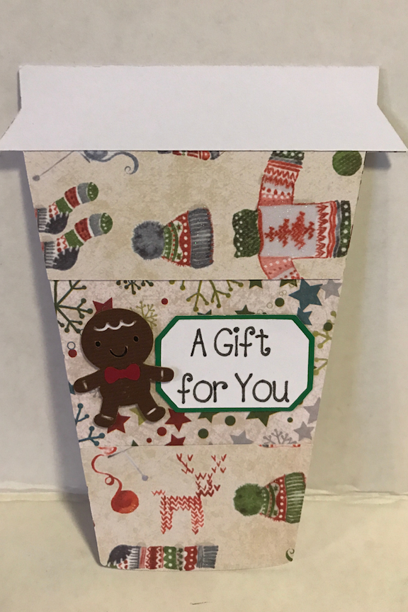 Gift cards make easy gifts, but aren't very pretty. Make your gift cards stand out in this easy to make coffee cup gift card holder for Christmas. Just find some pretty scrapbook paper and your Cricut, and get this DIY started. #DIY #Cricut #CricutMade #Coffee #GiftCardHolder #Christmas #ChristmasGift #ChristmasIdea #Xmas #scrapbook #Scrapbooking #tutorial 