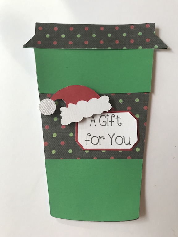 Gift cards make easy gifts, but aren't very pretty. Make your gift cards stand out in this easy to make coffee cup gift card holder for Christmas. Just find some pretty scrapbook paper and your Cricut, and get this DIY started. #DIY #Cricut #CricutMade #Coffee #GiftCardHolder #Christmas #ChristmasGift #ChristmasIdea #Xmas #scrapbook #Scrapbooking #tutorial 