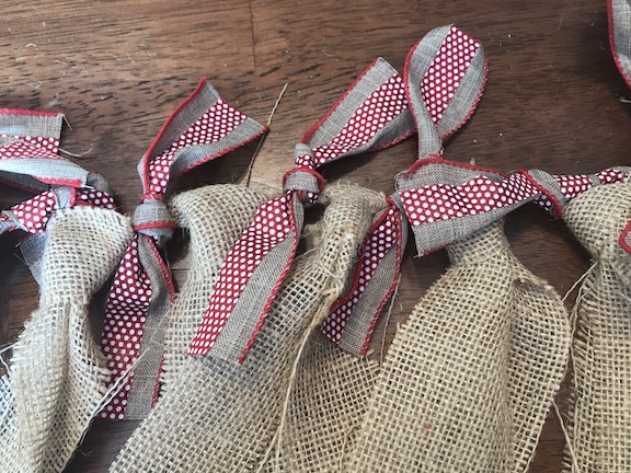 The kids will love counting down the days until Christmas with this candy cane and burlap countdown garland. The children will love eating a candy cane everyday waiting for Santa to come. Follow this easy DIY and create this fun craft. #CandyCane #Burlap #Garland #Christmas #ChristmasIdeas #ChristmasDecor #ChristmasGarland #Kids #ChristmasCountdown #Xmas