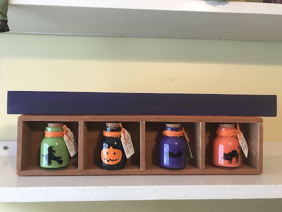 Painting the sign purple for Halloween Potion Bottle Display 