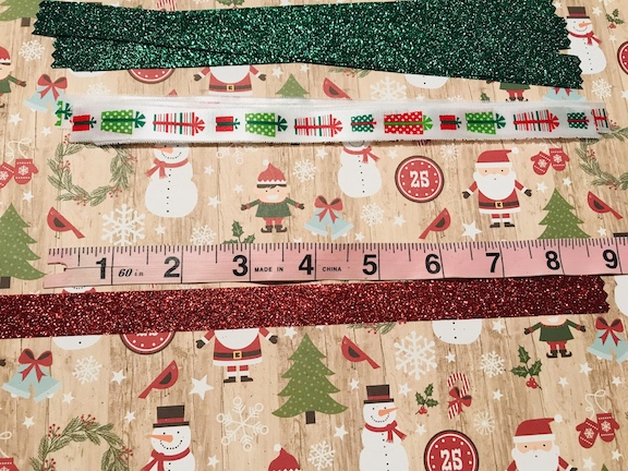 My daughter loves to wear her hair in a ponytail. Plain black hair ties/elastic are so boring. Learn how to make a cute DIY glittery Christmas ponytail holder with ribbon. #Christmas #Ponytail #DollarTree