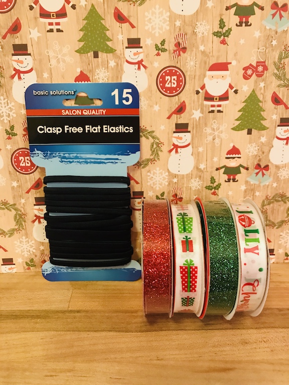 My daughter loves to wear her hair in a ponytail. Plain black hair ties/elastic are so boring. Learn how to make a cute DIY glittery Christmas ponytail holder with ribbon. #Christmas #Ponytail #DollarTree