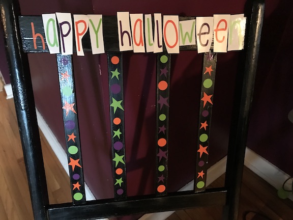 Decorating the Chair with the Cricut and Vinyl to create the design on the wooden chair 