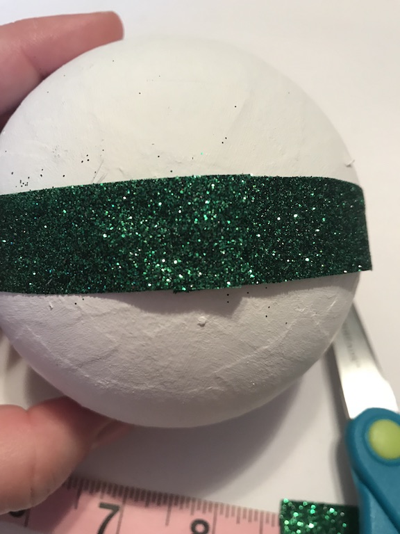 Measure the ribbon for the handmade ribbon Christmas Ornament from the Dollar Tree
