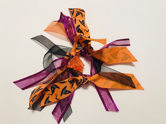 My daughter loves to wear her hair in a ponytail. Plain black hair ties/elastic are so boring. Learn how to make a cute DIY glittery Christmas ponytail holder with ribbon. #Christmas #Ponytail #DollarTree