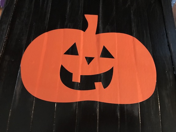 Cute Jack o'Lantern Pumpkin on the seat of the chair for Halloween 