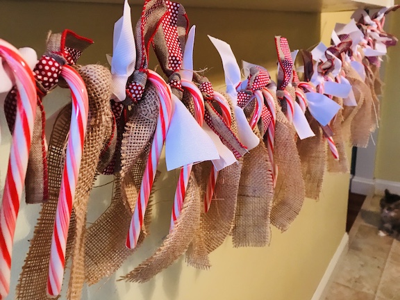 The kids will love counting down the days until Christmas with this candy cane and burlap countdown garland. The children will love eating a candy cane everyday waiting for Santa to come. Follow this easy DIY and create this fun craft. #CandyCane #Burlap #Garland #Christmas #ChristmasIdeas #ChristmasDecor #ChristmasGarland #Kids #ChristmasCountdown #Xmas