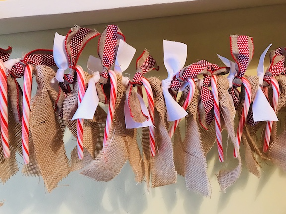 The kids will love counting down the days until Christmas with this candy cane and burlap countdown garland. The children will love eating a candy cane everyday waiting for Santa to come. Follow this easy DIY and create this fun craft. #CandyCane #Burlap #Garland #Christmas #ChristmasIdeas #ChristmasDecor #ChristmasGarland #Kids #ChristmasCountdown #Xmas