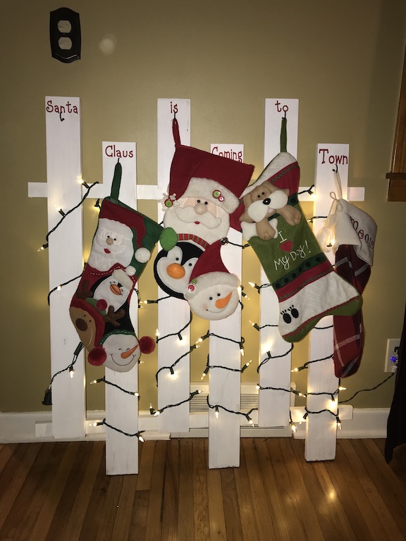 If you don't have a mantle, I have the perfect wooden stocking holder for your home. Your Christmas stockings for your family will look amazing on this DIY lighted stocking holder made with wood. #Christmas #ChristmasStockings #Homemade #DIY #ChristmasDecor #Family