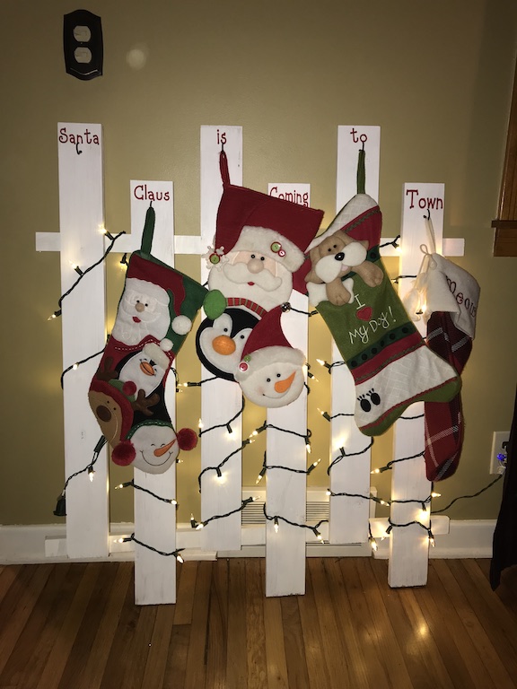 If you don't have a mantle, I have the perfect wooden stocking holder for your home. Your Christmas stockings for your family will look amazing on this DIY lighted stocking holder made with wood. #Christmas #ChristmasStockings #Homemade #DIY #ChristmasDecor #Family 