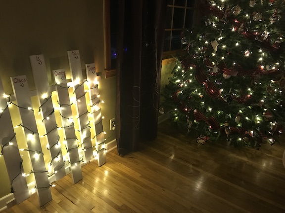 If you don't have a mantle, I have the perfect wooden stocking holder for your home. Your Christmas stockings for your family will look amazing on this DIY lighted stocking holder made with wood. #Christmas #ChristmasStockings #Homemade #DIY #ChristmasDecor #Family