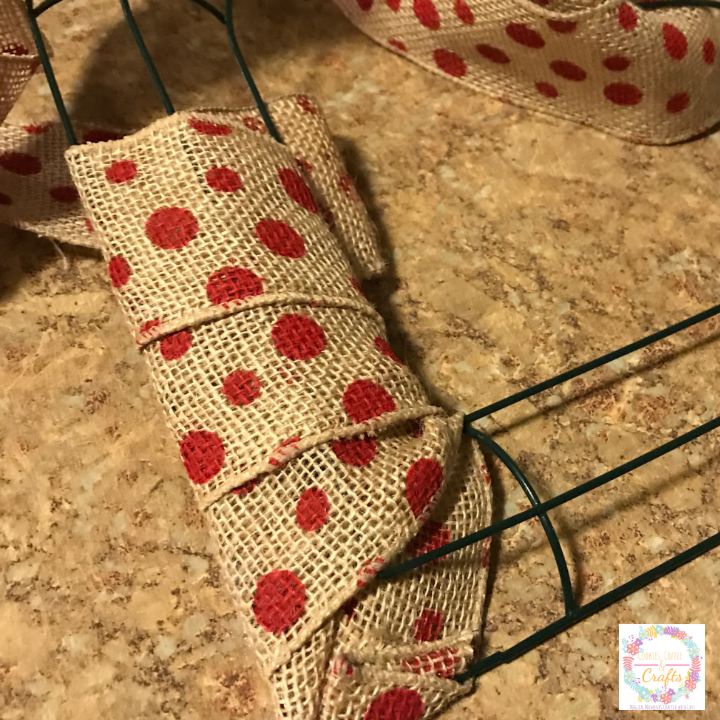 Wrapping the burlap ribbon around the heart wreath from the dollar store 