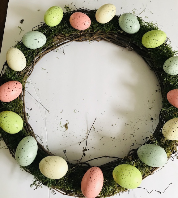 Hot Glue the Easter eggs evenly all over the top of the grapevine wreath 