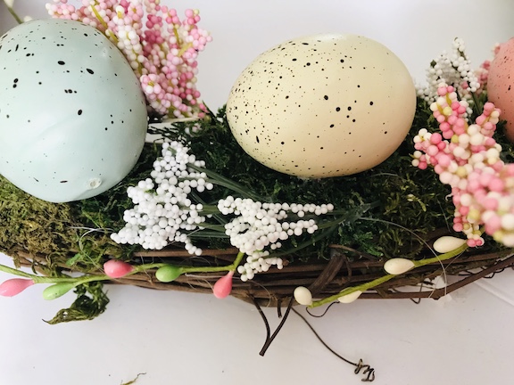 Around the Easter eggs hot glue all the sping florals on and around the Easter eggs