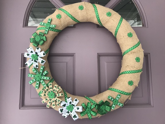 St. Patrick's Day is coming and you don't have to be Irish to decorate. Create this easy DIY Burlap St. Patrick's Day wreath for your front door. Make your home extra lucky with some four leaf clovers. #StPatricksDay #Wreaths #DIY #StPatricksDayWreath #Shamrock
