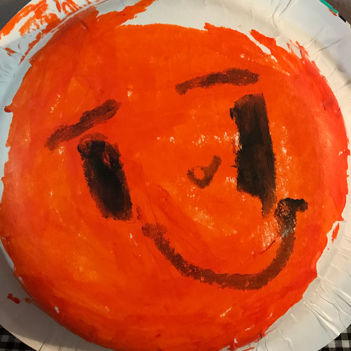 Make a double sided pumpkin paper bowl craft by adding a jack o lantern face on one side to make a halloween pumpkin