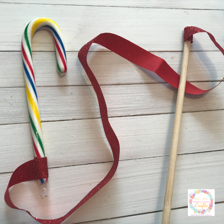 Using a dowel, ribbon, candy cane to make the fishing pole for game