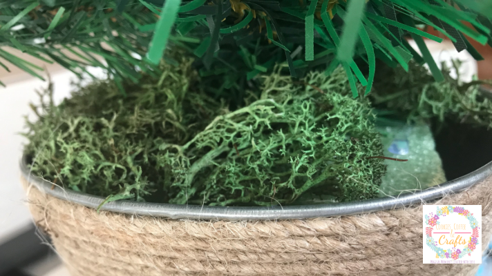Adding the reindeer moss to the Dollar Tree Christmas Decor Idea 