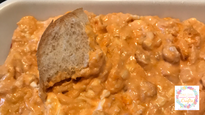 Dipping bread into buffalo chicken dip