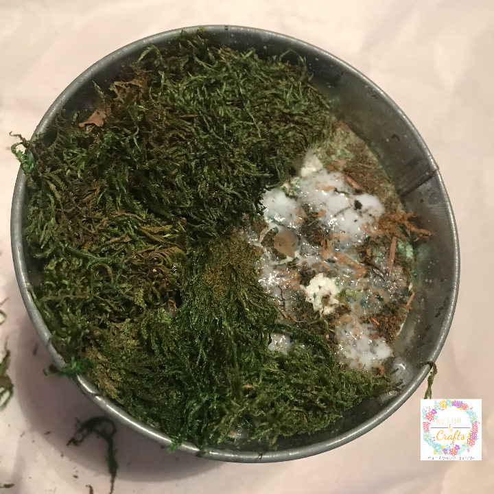 Adding moss to the top of the foam using the Mod Podge ultra spray for the easy Easter Decoration