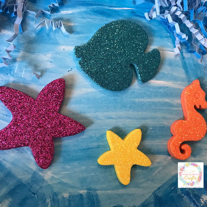 Adding sea creature foam stickers to the fun paper plate ocean craft for kids