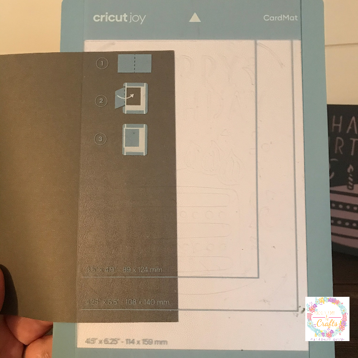 Sliding the insert card onto the Cricut Joy Card Mat