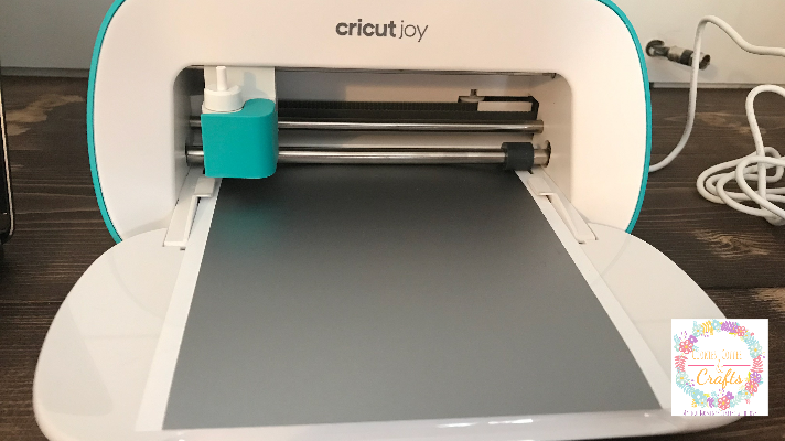 the Cricut Joy loading the Smart Materials Vinyl 