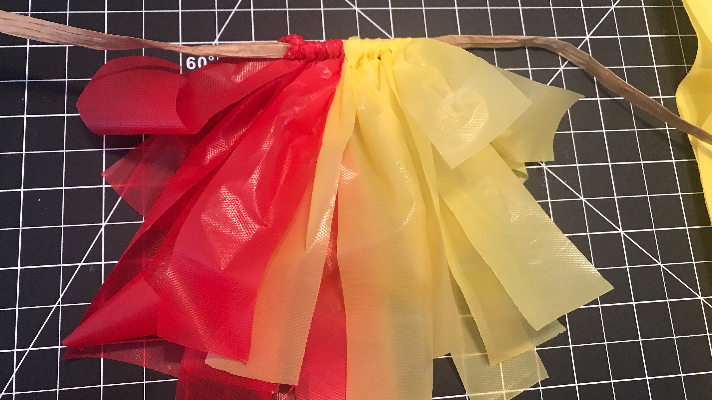 Creating a car parade decoration with a multi colored plastic tablecloths
