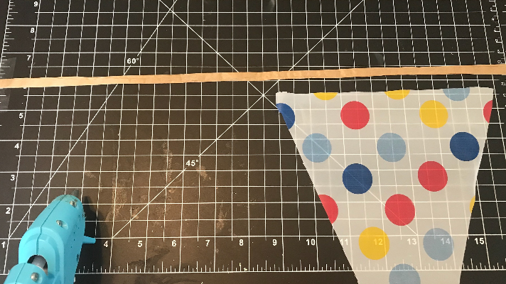 Creating banners for the back of the car with tablecloths, ribbon, and hot glue 
