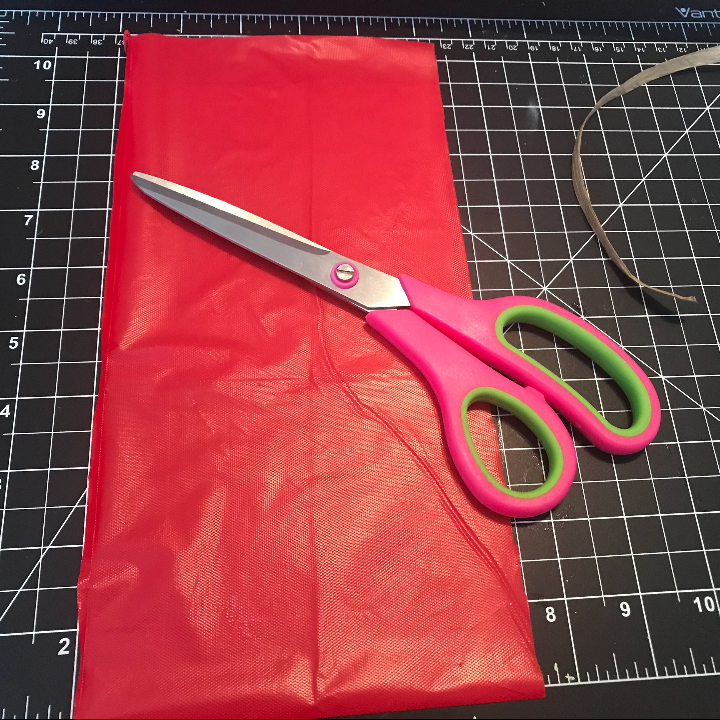 Cutting the plastic tablecloth for the car garland