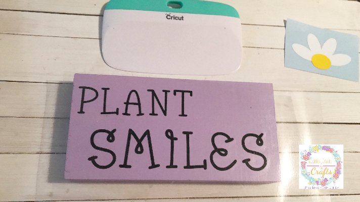 Using the Cricut Scraper and transfer tape add the vinyl to the wood block sign