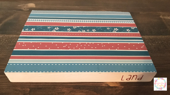 Adding patriotic scrapbook paper to the top of the faux patriotic books