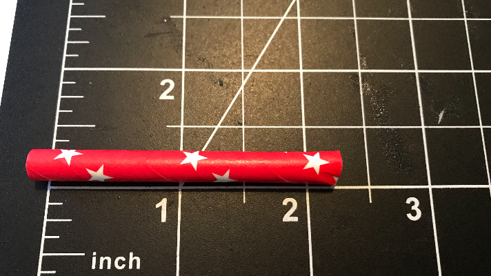 Cutting the paper straws about 2 inches long for the patriotic necklace for the 4th of July 