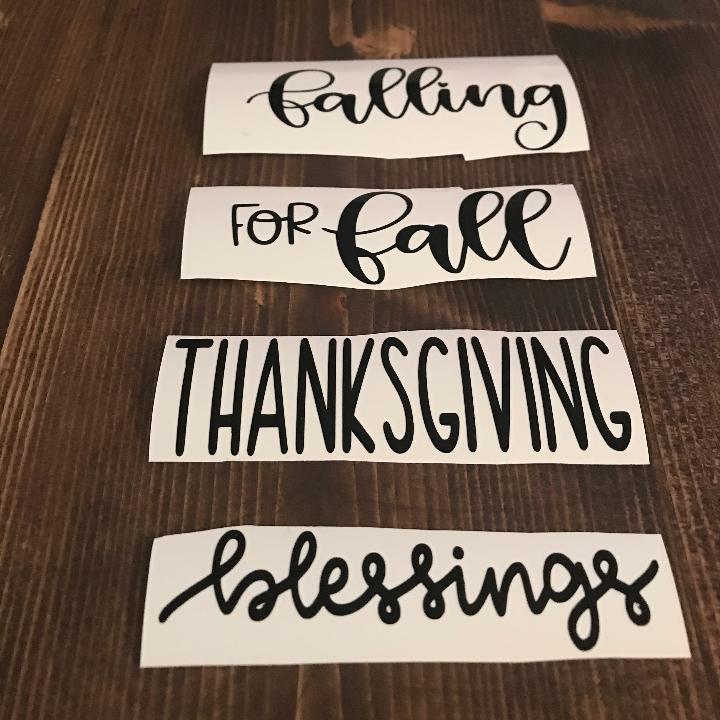 Fall and Thanksgiving sayings cut in Cricut Joy Smart Vinyl for the 2x4 wooden books