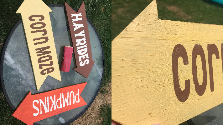 Giving the yard sign a light sanding for a rustic weather look