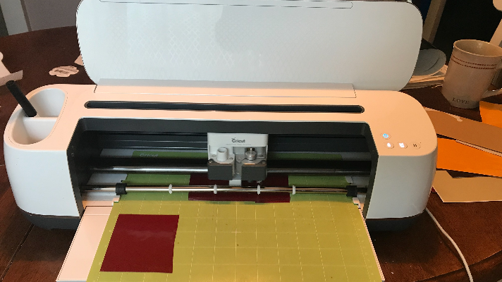 Cricut Maker cutting the design for the DIY fall pizza pan wreath