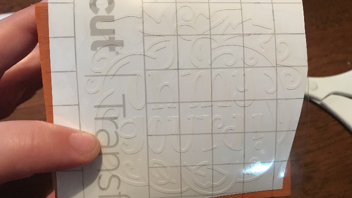 Using the Cricut Smart Transfer Tape to add the vinyl to the wooden dice