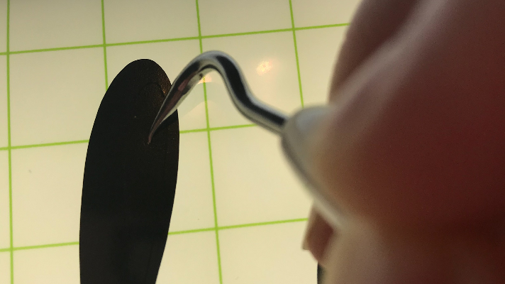 Weeding the vinyl design using the Cricut tools