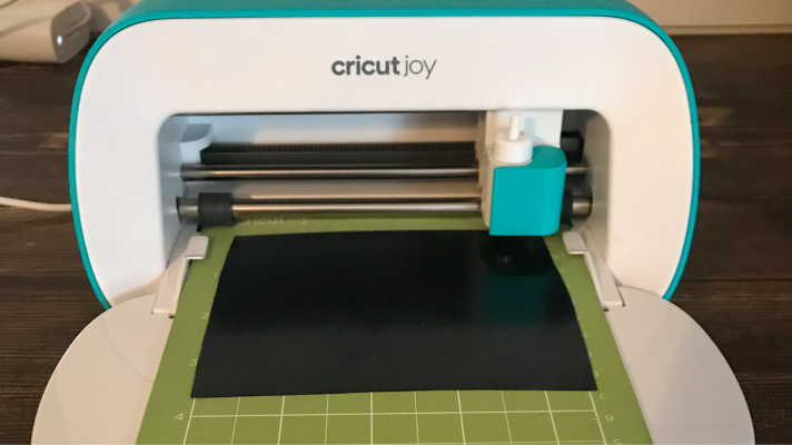 Cricut Joy Cutting the black iron on to make a Cricut Christmas Ornament