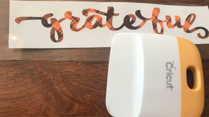 Use transfer tape and the Cricut tools to add the vinyl to the sign