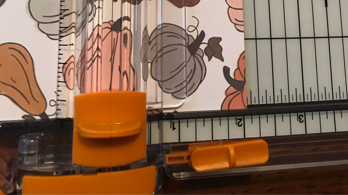 Using the cutting board to cut the strips of paper for the toilet paper roll