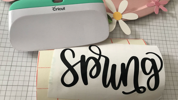 Adding hello spring to the dollar tree pizza pan craft