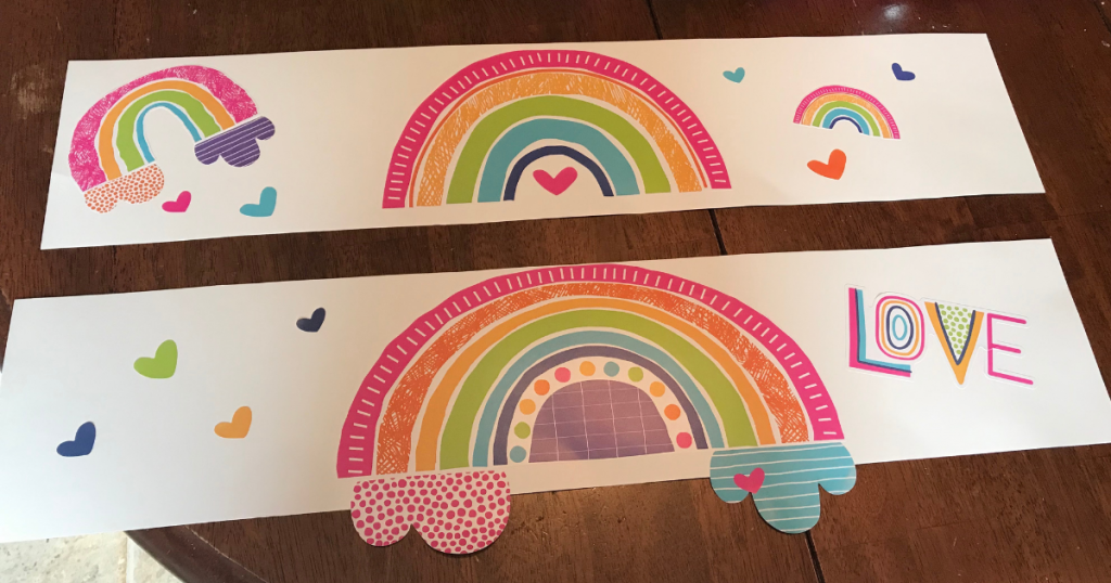add the rainbow wall decal to the strips of pasteboard for a simple birthday decoration 